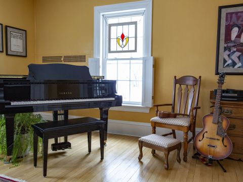 Baby grand piano, guitar & ukulele in the living room - photo by Robin Farrin