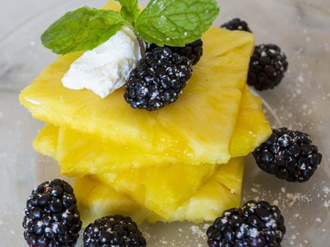 Fresh pineapple slices and blackberries