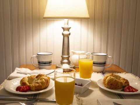 Breakfast tabletop with croissants and beverages